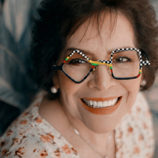 Adult model wearing Barledear Checkerboard Spectrum asymmetric geometric acetate eyeglasses in a bold modern street-style portrait.
