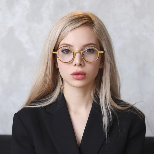 Model wearing Barledear Golden Walnut round pure titanium eyeglasses in a lifestyle portrait showing a lightweight design for everyday wear