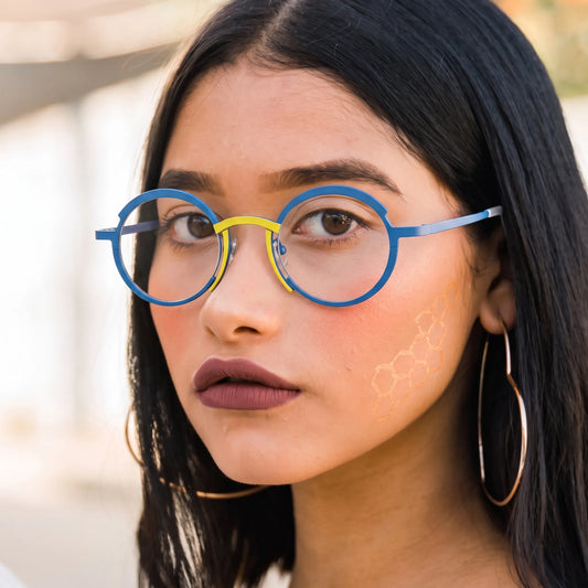Model wearing Barledear Ocean Blue Sunshine Yellow titanium round eyeglasses worn in a stylish lifestyle portrait showing the medium-fit frame