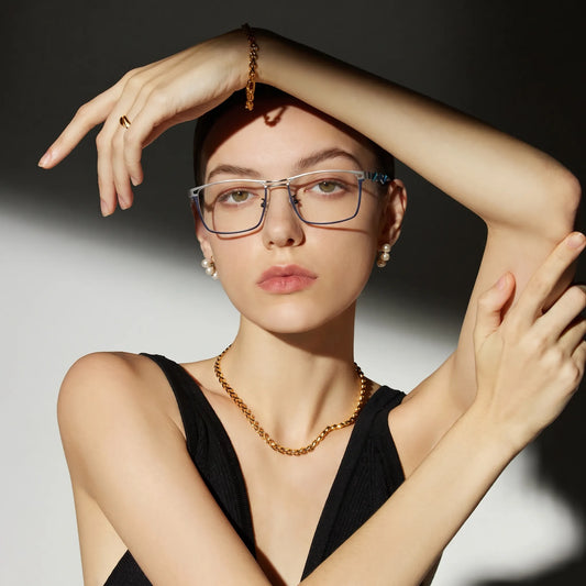 Model wearing Barledear Titan Sky Blue eyeglasses with lightweight square titanium frame in a lifestyle portrait