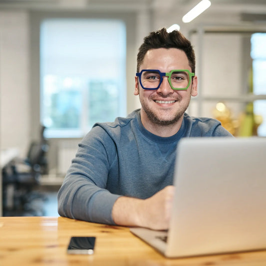 Model showcasing VoyueLens Blue-Green Matte eyeglasses in a clean, urban fashion setting