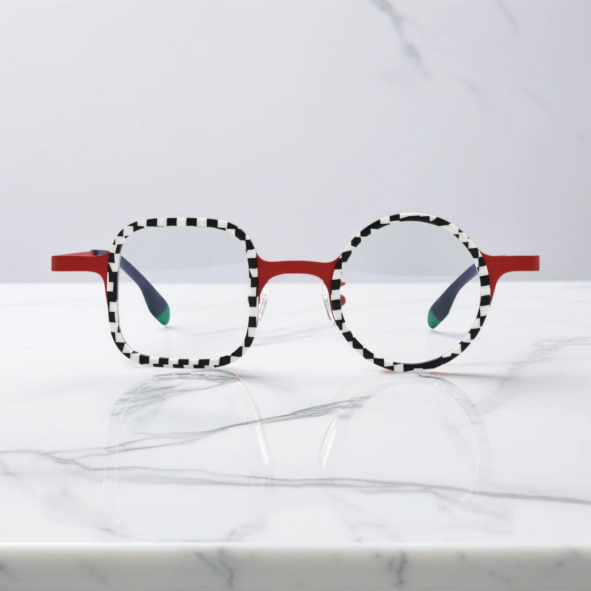 Front view of VoyueLens Checker Clash Red eyeglasses with high-contrast checker rims and asymmetrical dual-shape frame, part of the BARLEDEAR collection.