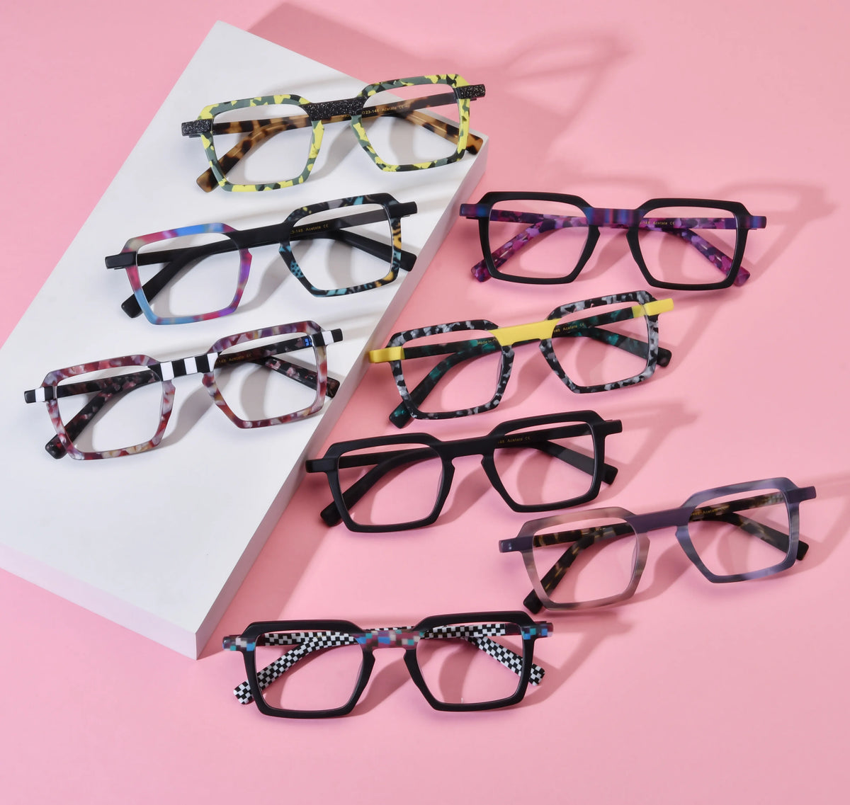 Barledear patchwork acetate square eyeglasses lifestyle group image showing all eight colorful frame variants on a pink background