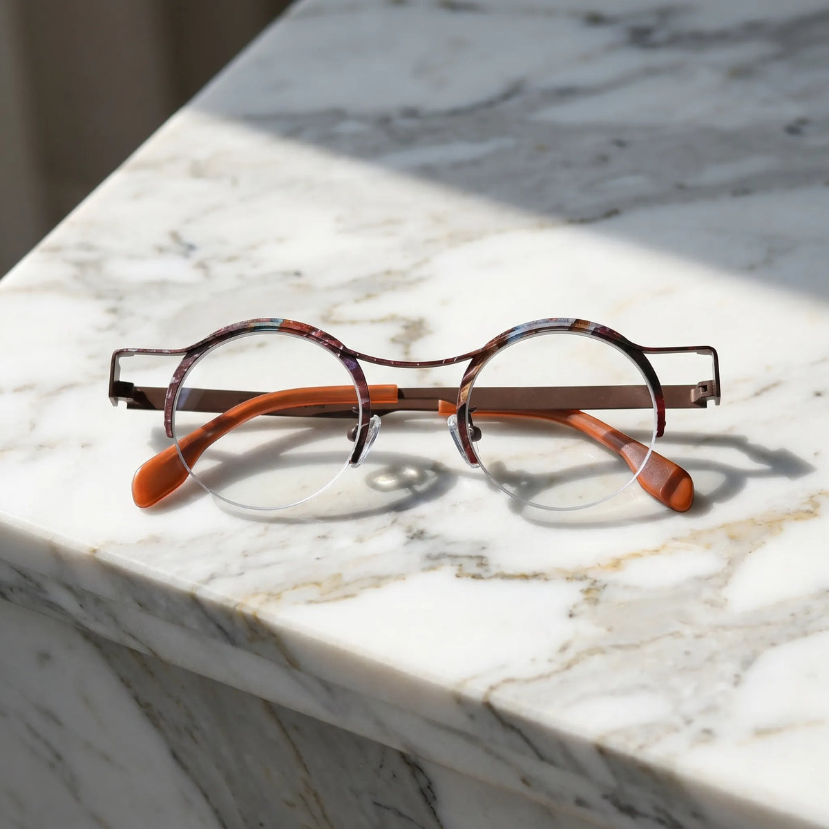 Barledear Amber Cocoa eyeglasses folded display showing slim titanium temples and warm amber color-spliced finish