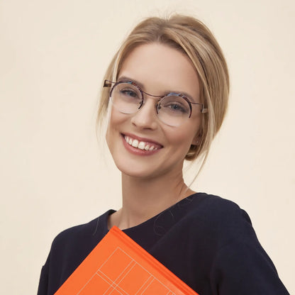 Model wearing Barledear Amber Cocoa eyeglasses in a lifestyle portrait showing warm retro round titanium eyewear style