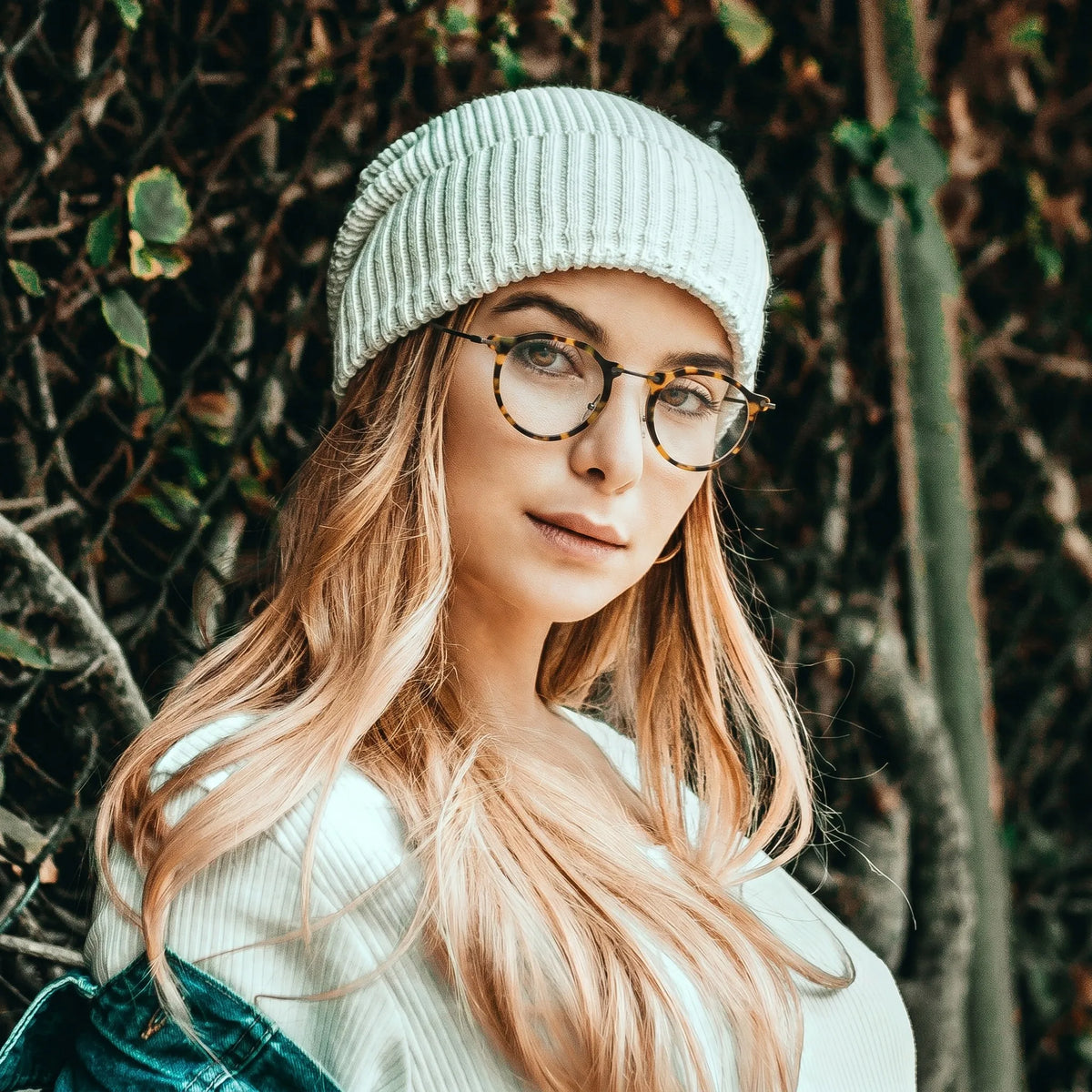 Model wearing Barledear Amber Leopard eyeglasses in a lifestyle portrait showing the retro oval acetate metal frame