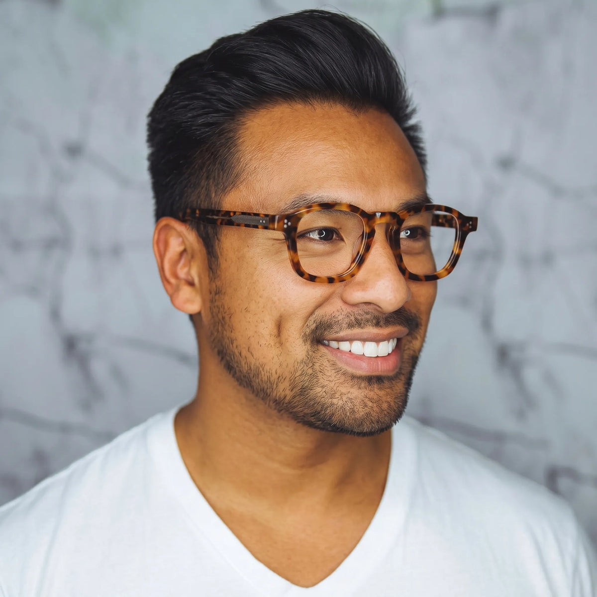 model wearing Barledear Amber Leopard Tortoise eyeglasses in a lifestyle portrait with retro square acetate frame