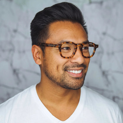 model wearing Barledear Amber Leopard Tortoise eyeglasses in a lifestyle portrait with retro square acetate frame