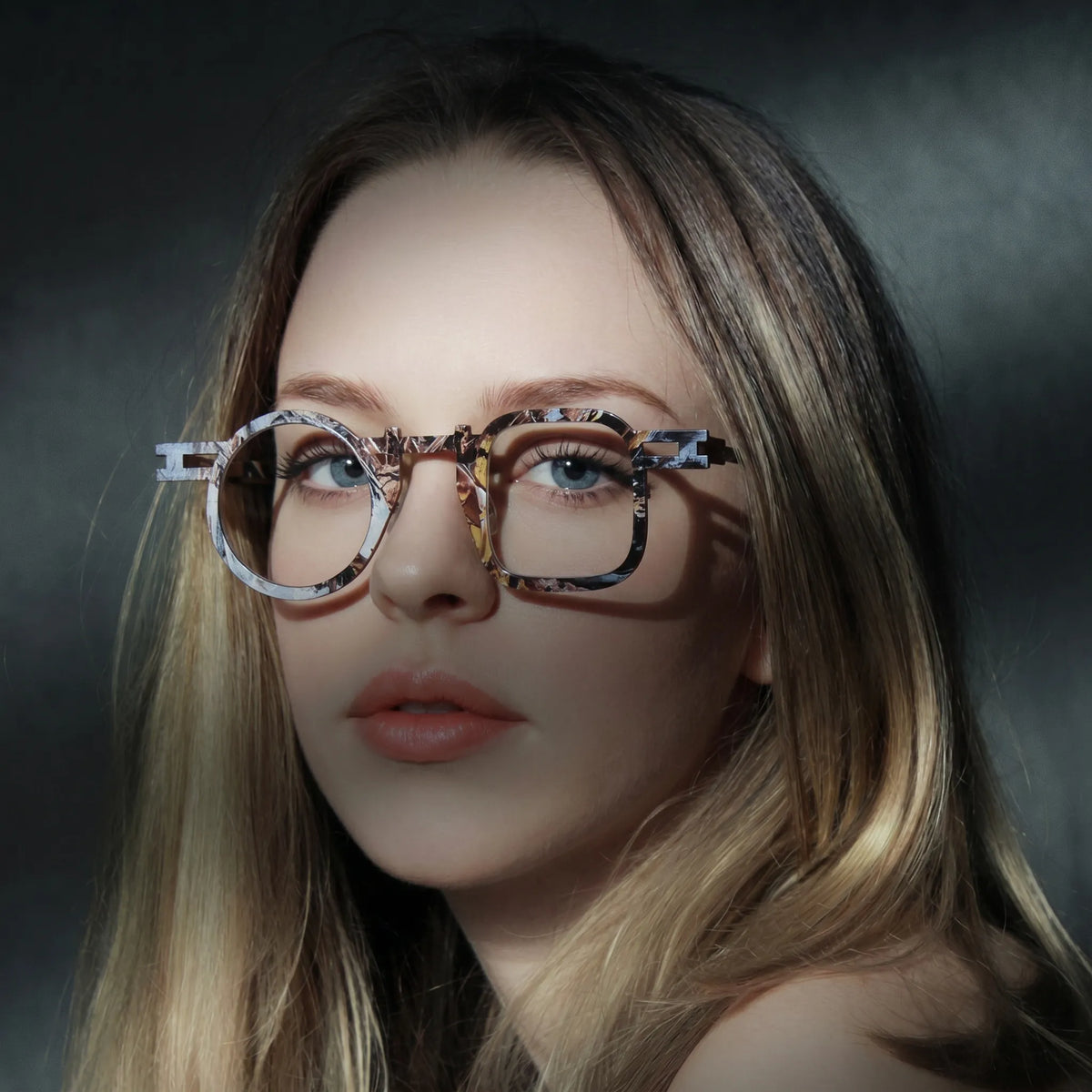 Model wearing Barledear Amber Mosaic Brown eyeglasses in a lifestyle portrait with asymmetric geometric titanium frame