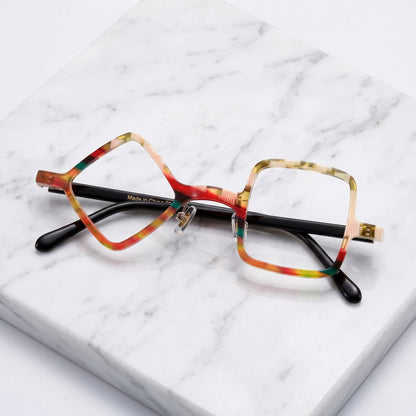Barledear Amber Mosaic asymmetric geometric acetate eyeglasses folded display showing the warm patterned front, adjustable nose pads, and black temples.