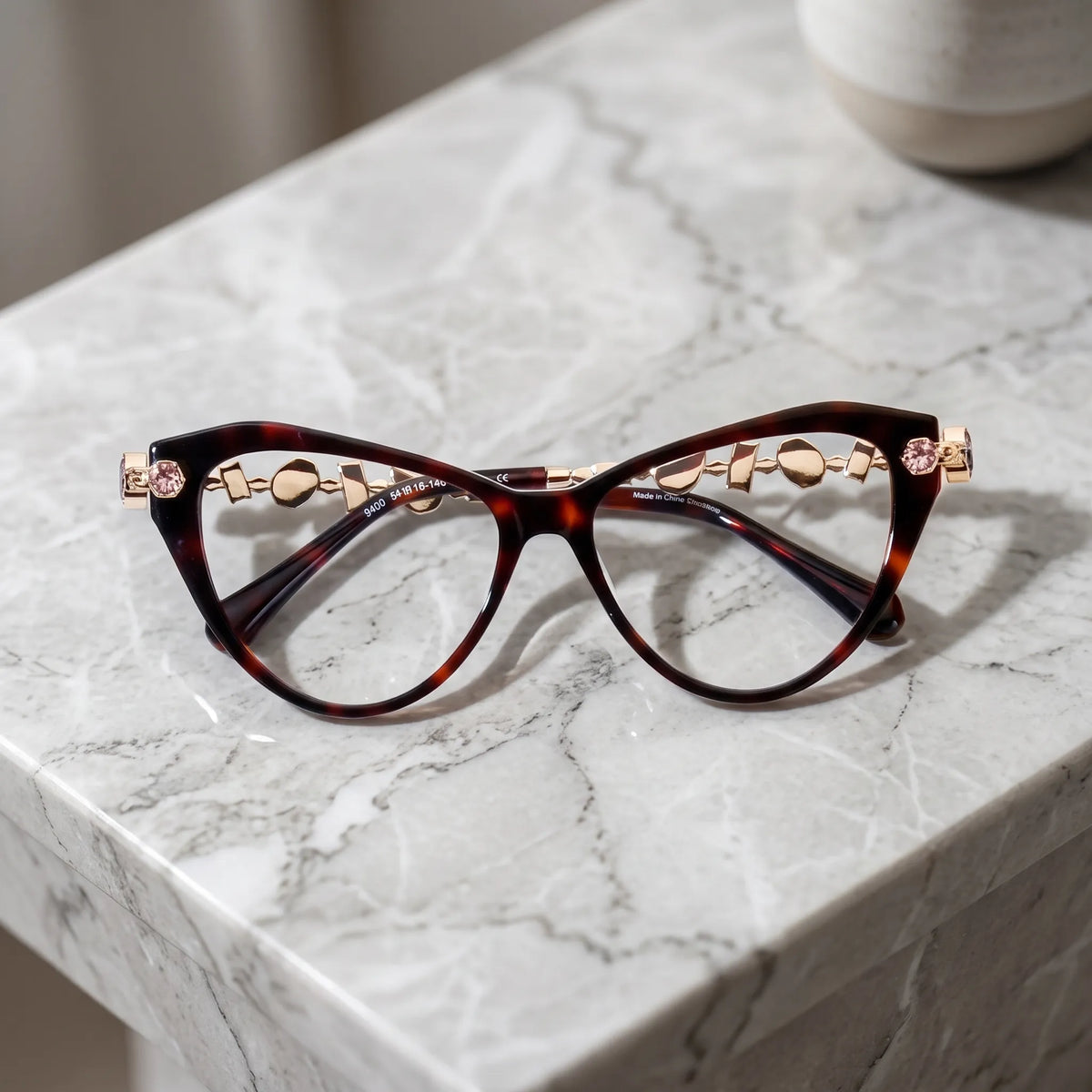 Barledear Amber Tortoise eyeglasses folded display showing the polished tortoise acetate front, integrated nose bridge, and decorative metal temples