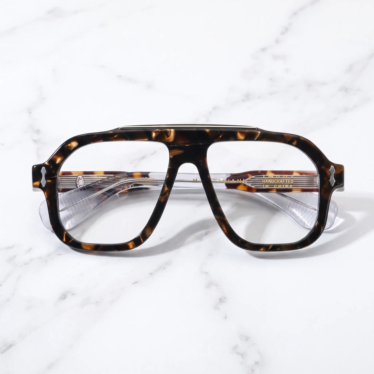 Barledear Amber Tortoise eyeglasses folded display showing the patterned acetate front, transparent temples and metal hinge detailing