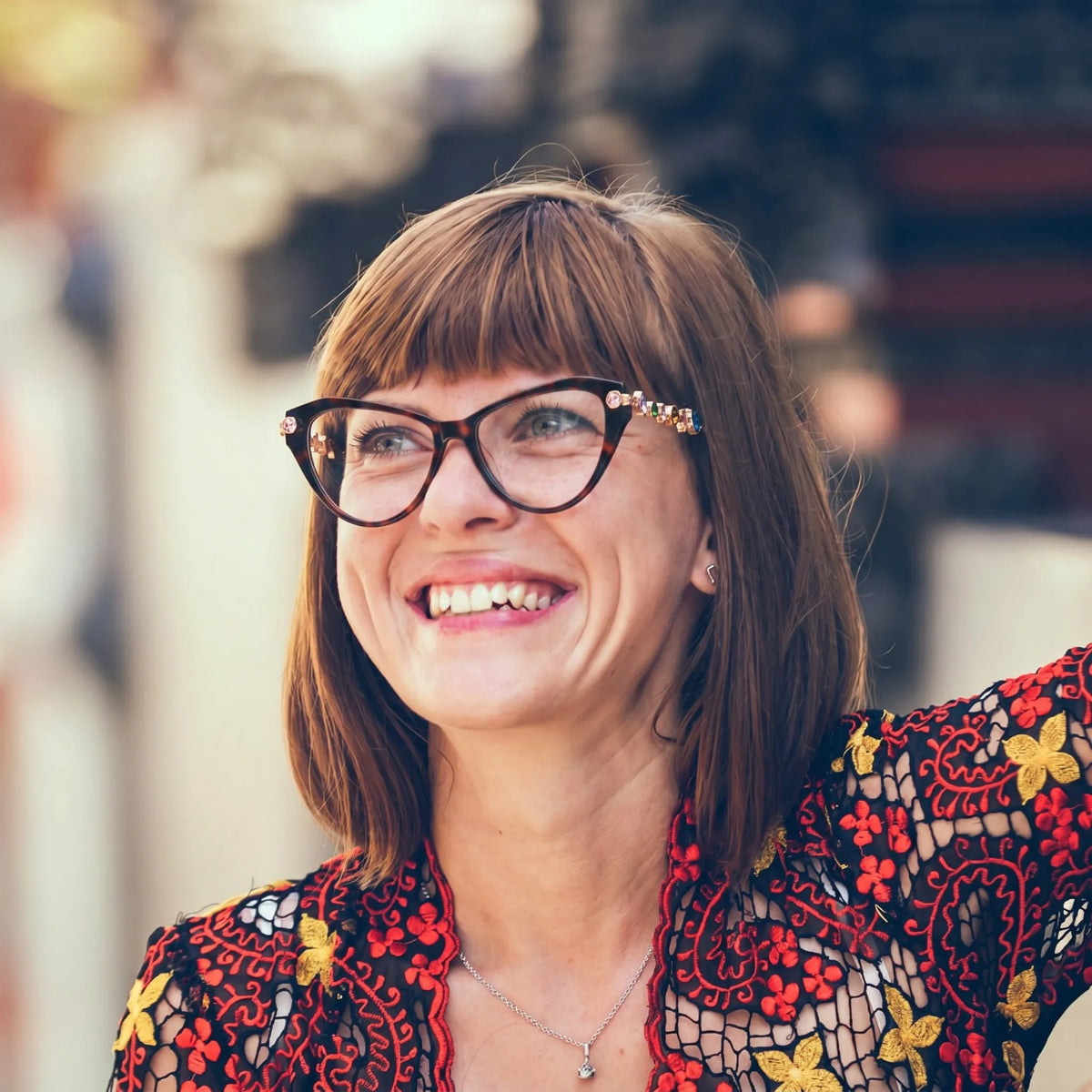 Adult woman wearing Barledear Amber Tortoise geometric cat-eye eyeglasses in an elegant fashion lifestyle portrait