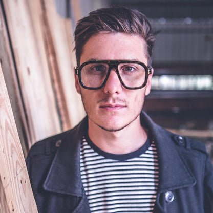 Adult model wearing Barledear Amber Tortoise square aviator acetate eyeglasses with transparent temples for a retro casual look