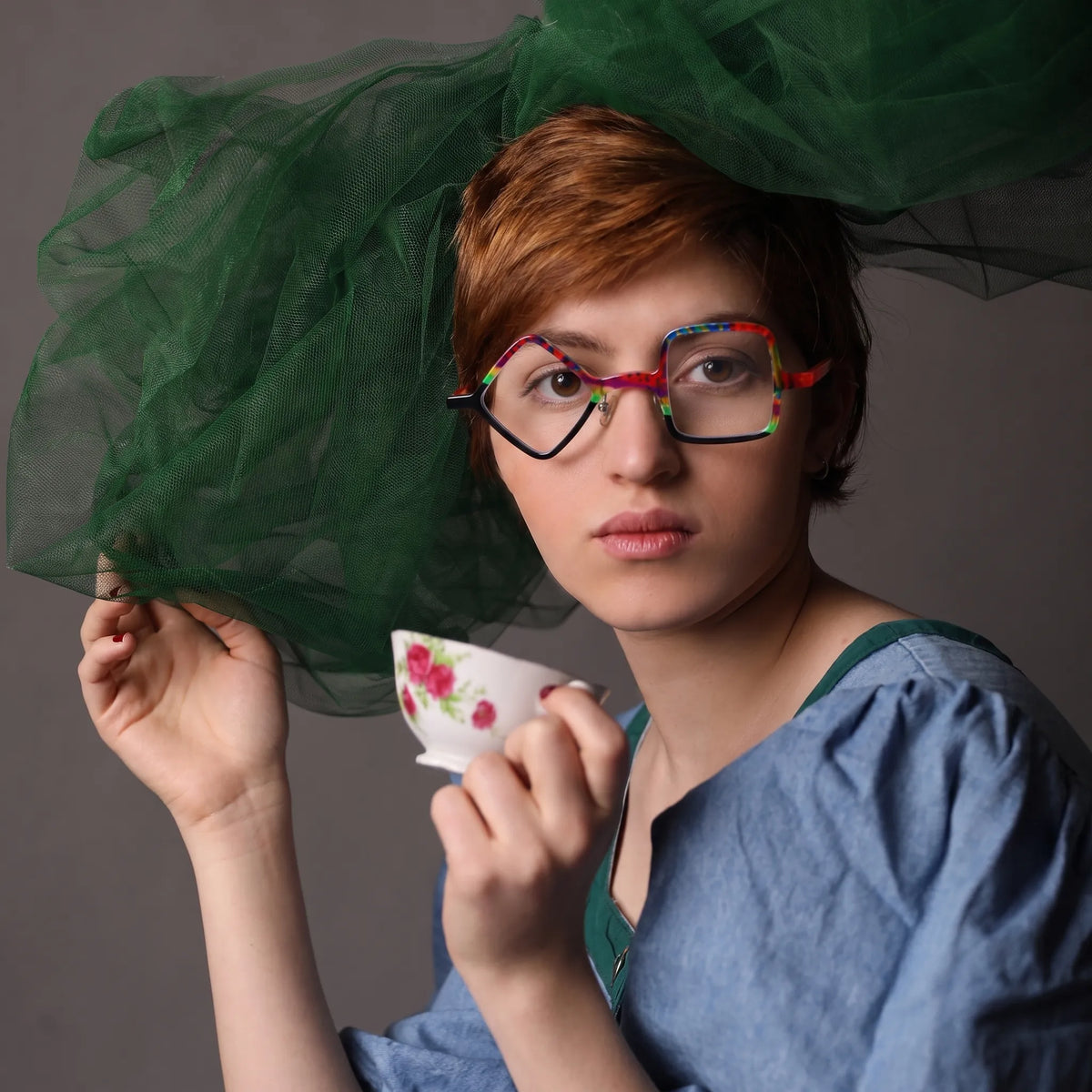 Adult model wearing Barledear Carnival Noir asymmetric geometric acetate eyeglasses in a colorful punk-inspired streetwear portrait.