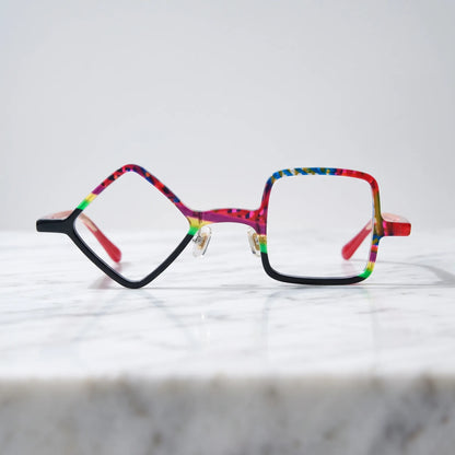 Barledear Carnival Noir asymmetric geometric acetate eyeglasses shown in a clean lifestyle front display with vibrant color blocking and black contrast details.