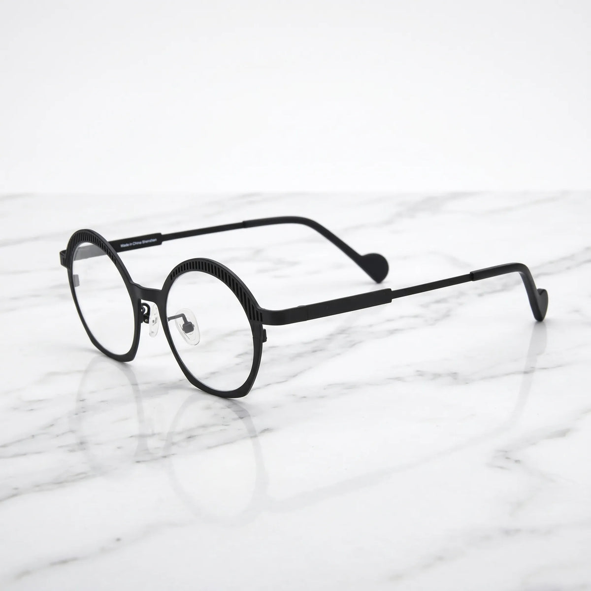 Barledear Charcoal Black eyeglasses angled side view showing slim titanium temples, curved black temple tips, and decorative slotted browline
