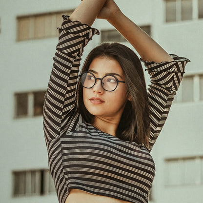 Model wearing Barledear Charcoal Black eyeglasses in a lifestyle portrait with clean lightweight geometric titanium frame