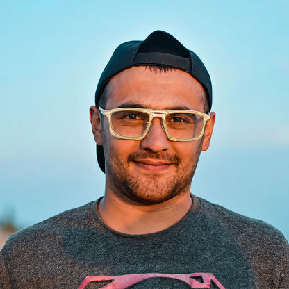 Model wearing Barledear Citrus Ivory eyeglasses in a lifestyle portrait with lightweight square titanium frame styling