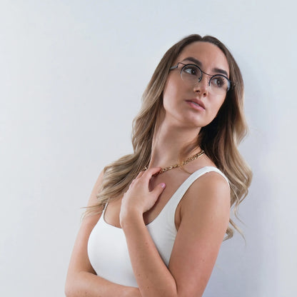 Model wearing Barledear Classic Noir eyeglasses in a lifestyle portrait showing clean black retro round titanium frame style