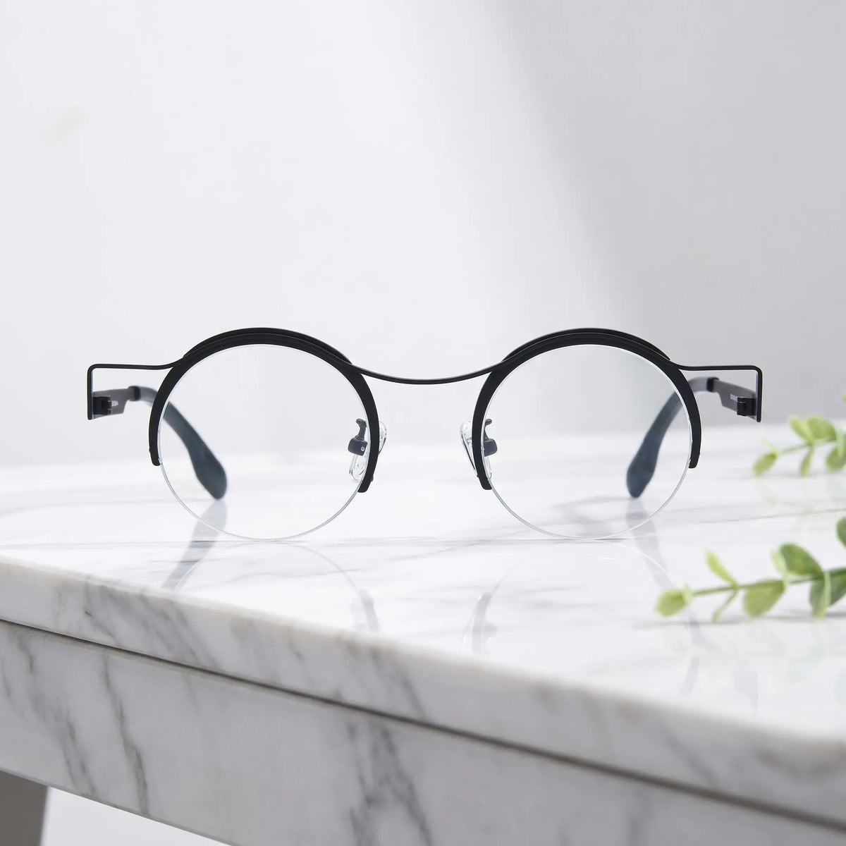 Barledear Classic Noir eyeglasses shown in a clean lifestyle front view with minimalist retro round titanium frame