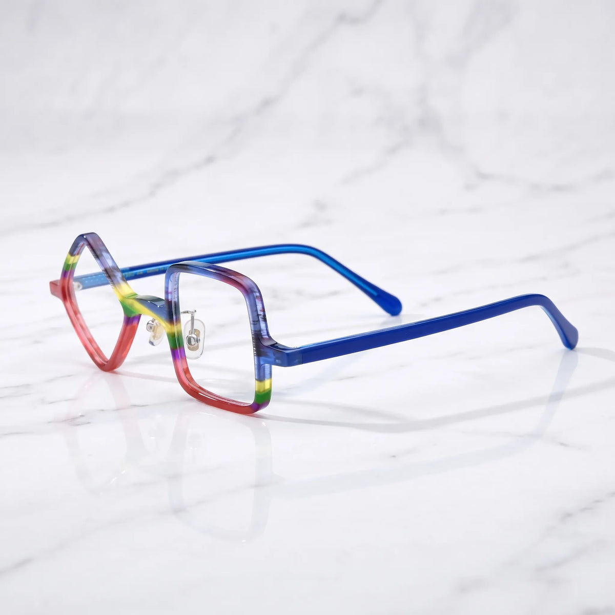 Barledear Cobalt Crimson asymmetric geometric acetate eyeglasses angled side view showing the layered red and blue frame, metal hinges, and slim cobalt temples.