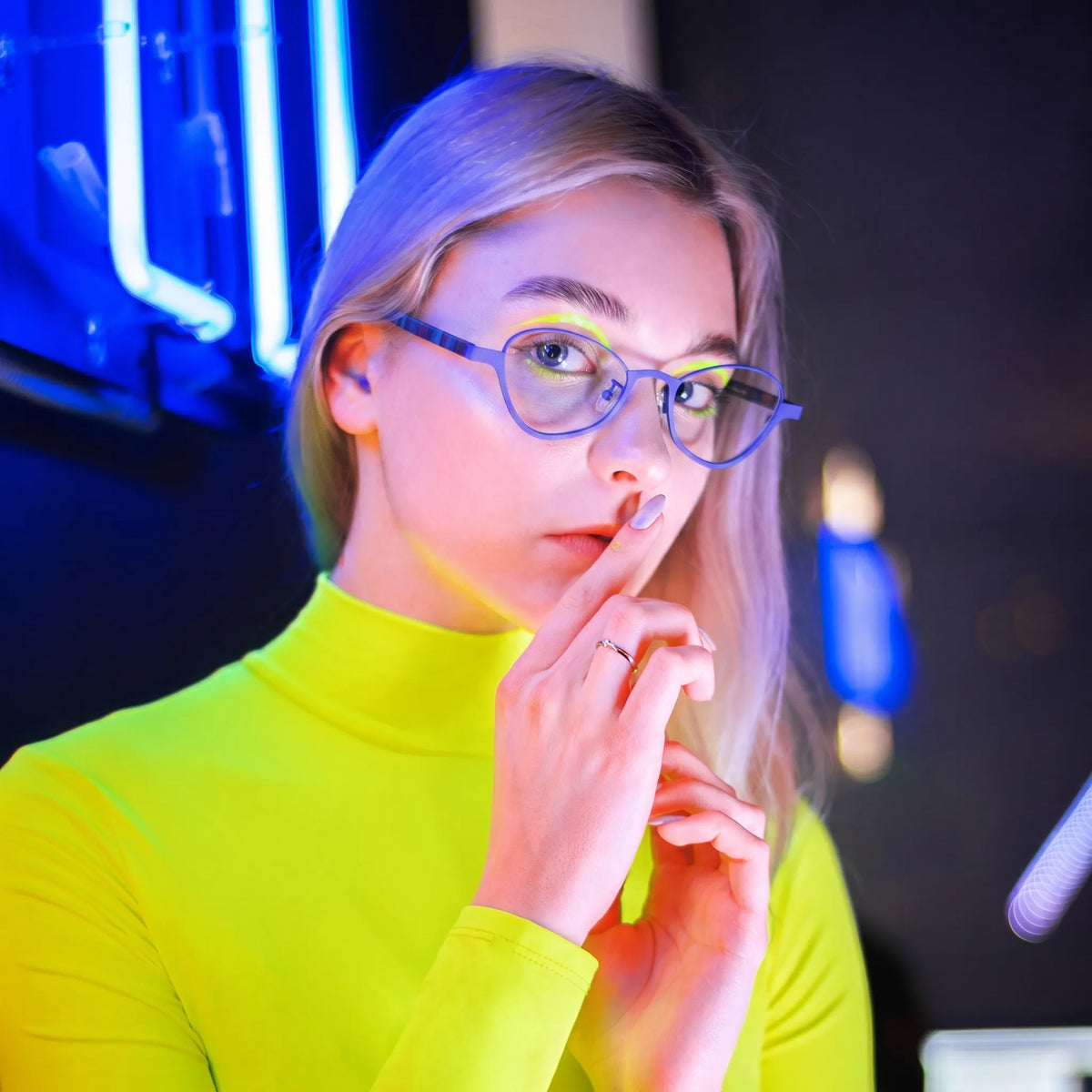 Model wearing Barledear Cobalt Mosaic oval titanium eyeglasses in a lifestyle portrait