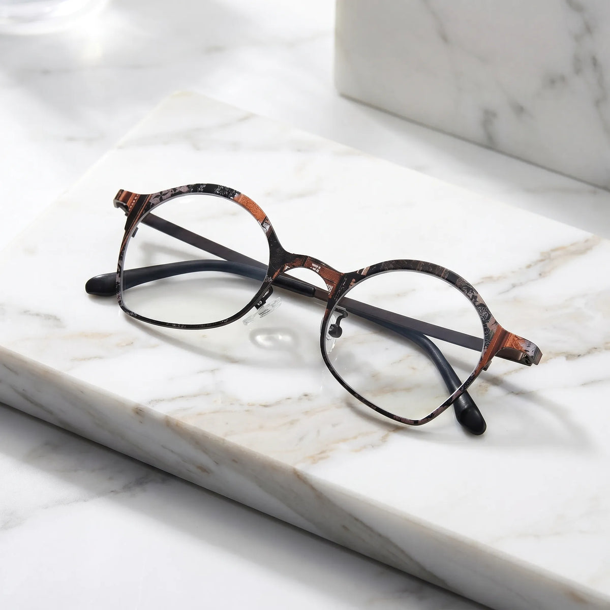 Barledear Copper Noir Brown eyeglasses folded display showing patterned titanium frame and slim temples