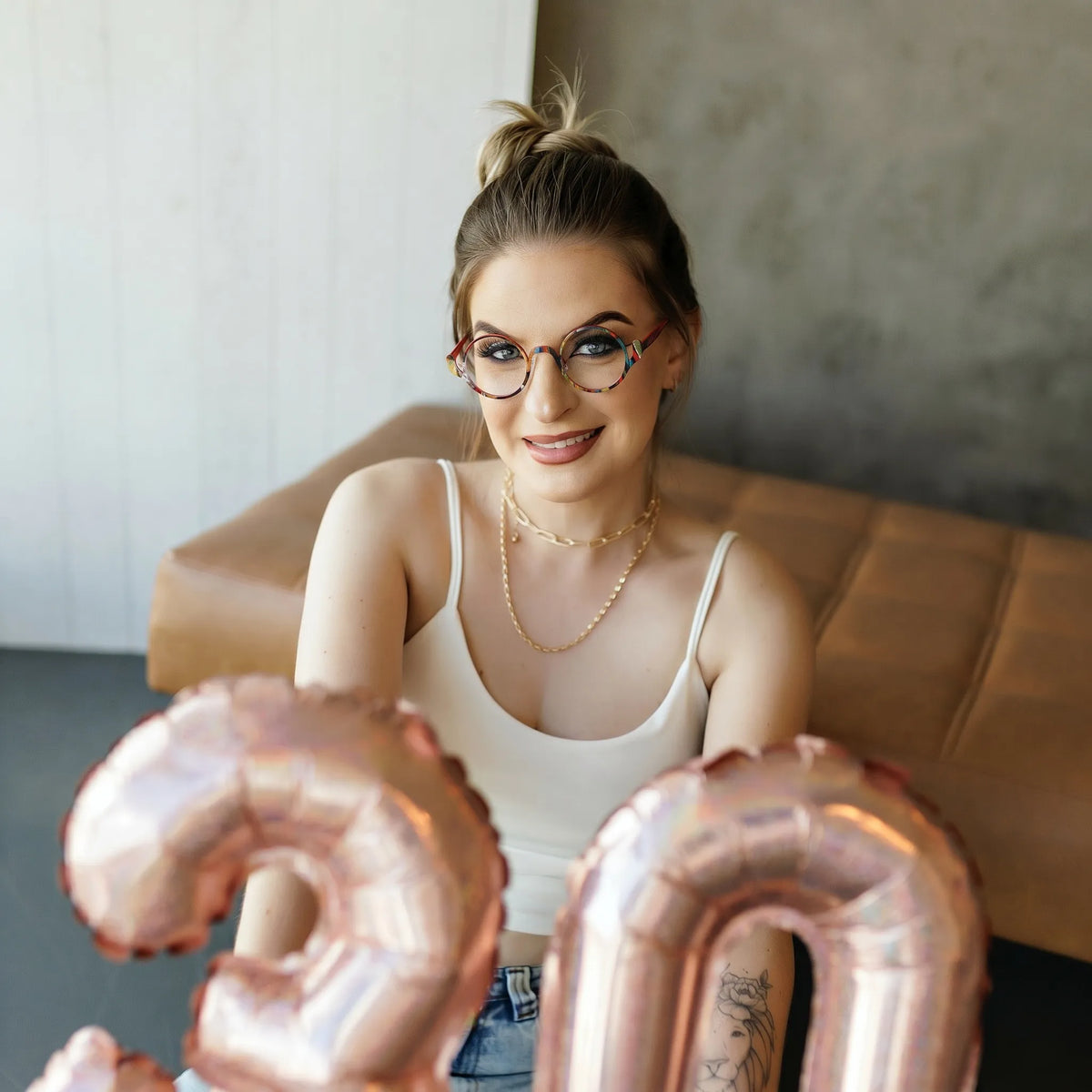 Model wearing Barledear Crimson Artline eyeglasses in a lifestyle portrait showing the artistic round pure titanium frame on the face