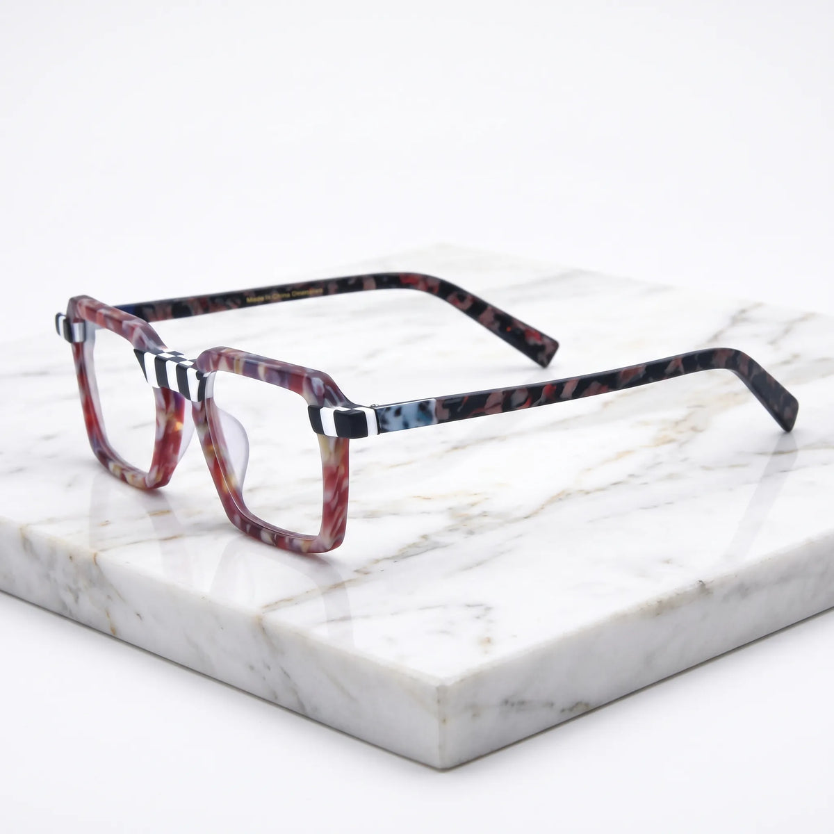 Barledear Crimson Checker Bloom square eyeglasses angled side view showing checkerboard accents and patterned temples