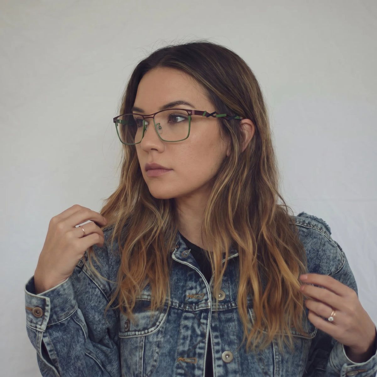 Model wearing Barledear Crimson Meadow Green eyeglasses with lightweight geometric titanium frame in a lifestyle portrait