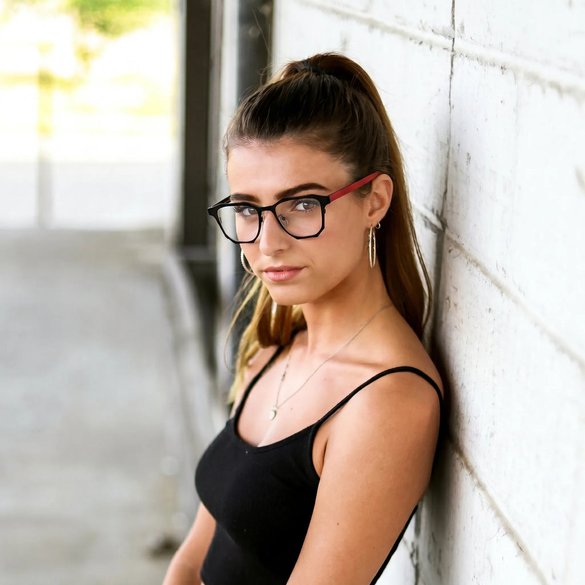 Model wearing Barledear Crimson Noir eyeglasses with bold black geometric square frame in a lifestyle portrait