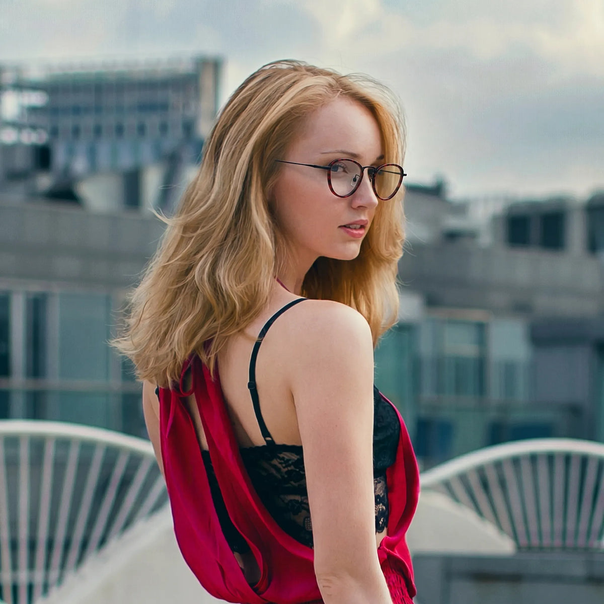 Model wearing Barledear Crimson Noir eyeglasses in a lifestyle portrait with refined geometric frame styling