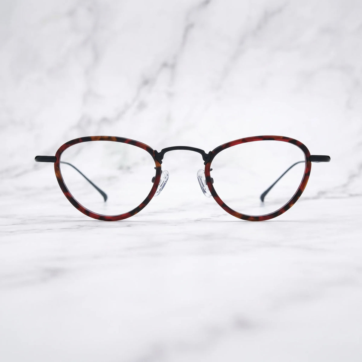 Barledear Crimson Noir eyeglasses shown in a clean lifestyle front view with crimson tortoise acetate and black titanium details