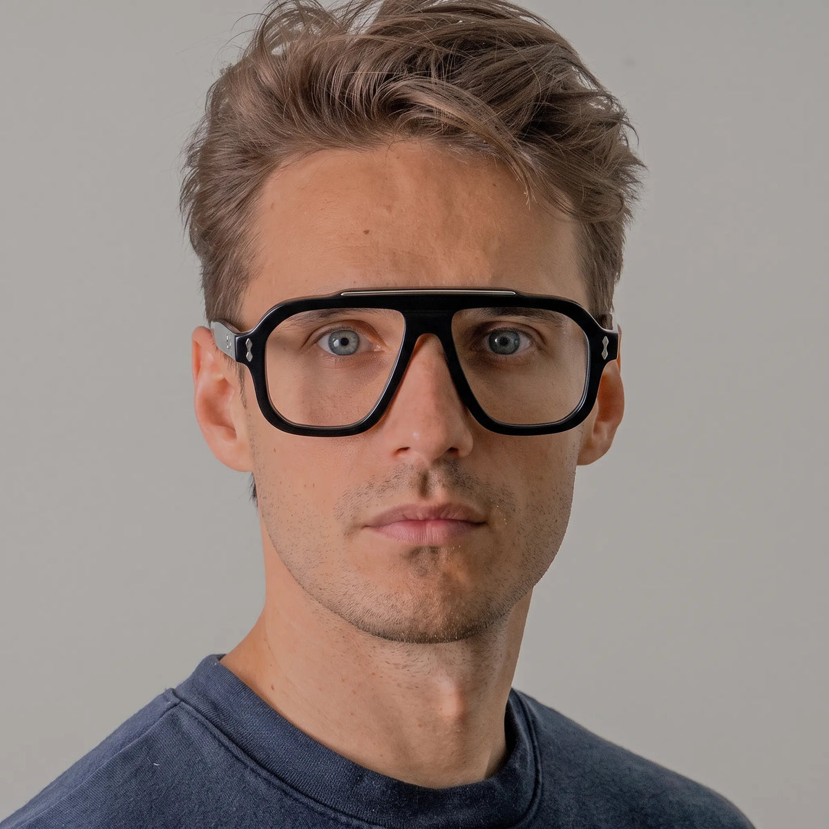 Adult model wearing Barledear Crystal Noir square aviator acetate eyeglasses with a polished black front and transparent temples