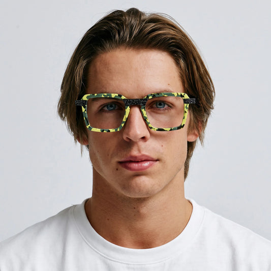 Model wearing Barledear Electric Moss Tortoise square eyeglasses in a colorful lifestyle portrait