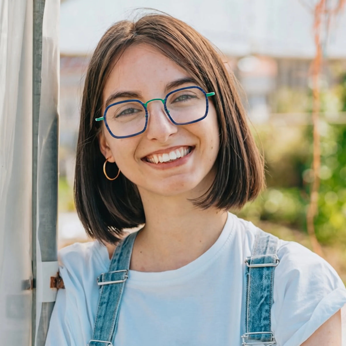 Model wearing Barledear Emerald Graphite Green eyeglasses in a lifestyle portrait