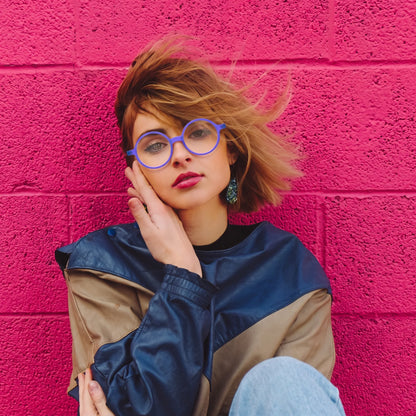 Model wearing Barledear Frosted Iris Blue round acetate eyeglasses in a lifestyle portrait showing the lightweight frosted frame fit