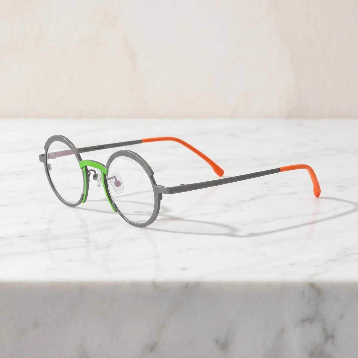 Barledear Graphite Gray Citrus Orange eyeglasses angled side view showing adjustable nose pads, slim titanium temples, and bridge construction