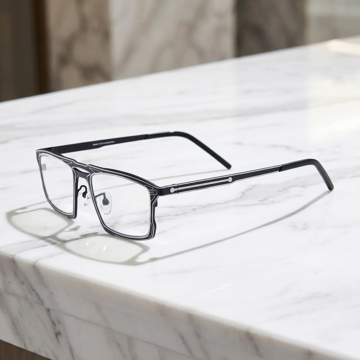 Barledear Graphite Noir eyeglasses angled side view showing slim dual-tone temples, bridge detail, and adjustable nose pads