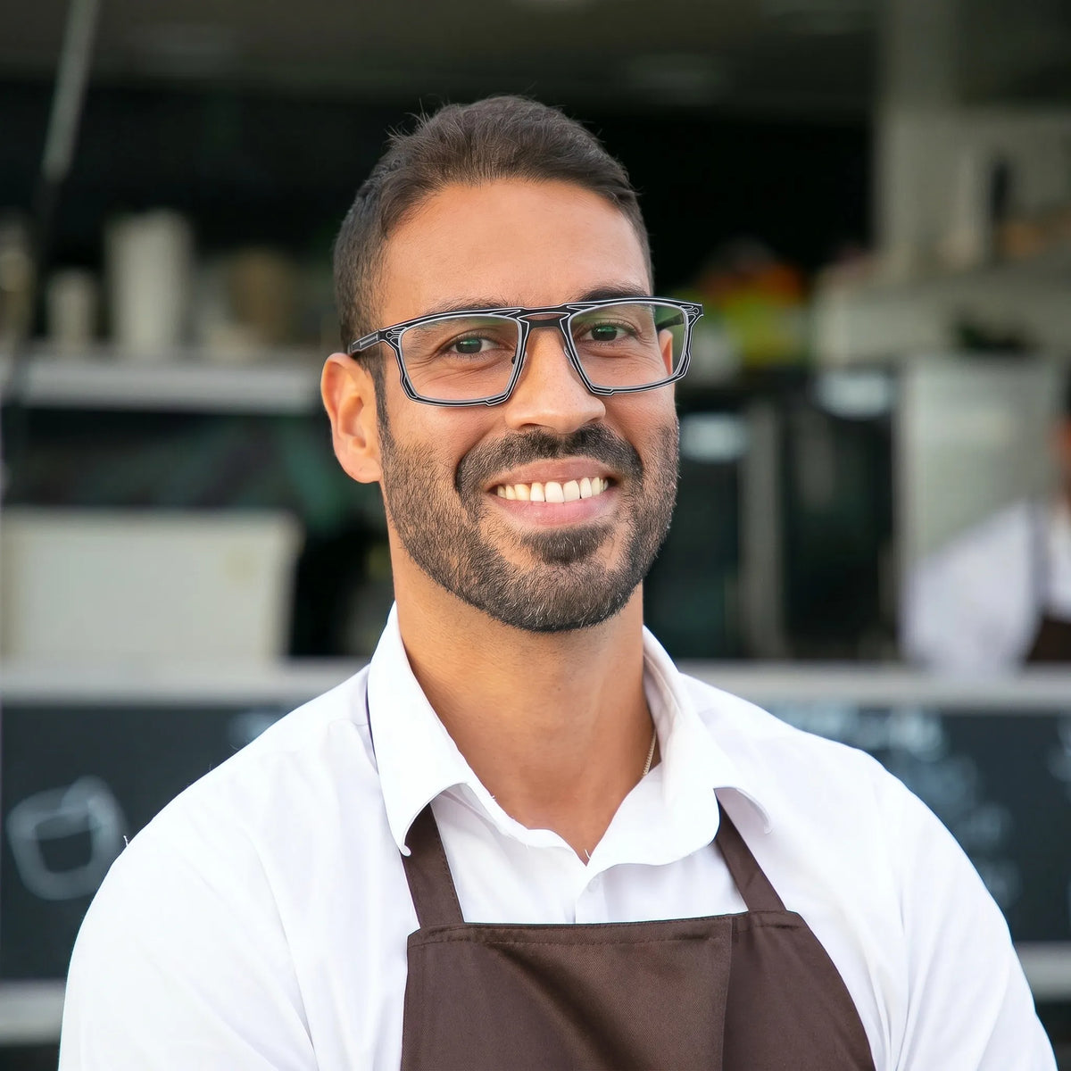 Model wearing Barledear Graphite Noir eyeglasses in a lifestyle portrait with lightweight square titanium frame styling