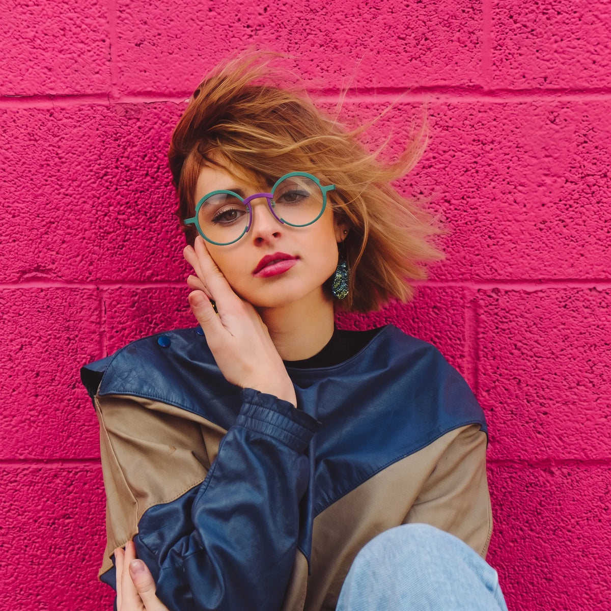 Model wearing Barledear Jade Green Violet Purple titanium round eyeglasses worn in a stylish lifestyle portrait showing the medium-fit frame