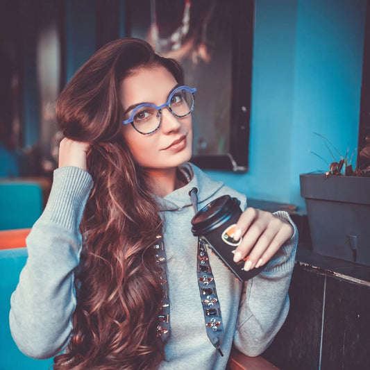 Model wearing Barledear Lavender Mosaic eyeglasses in a lifestyle portrait showing lightweight geometric oval titanium frame