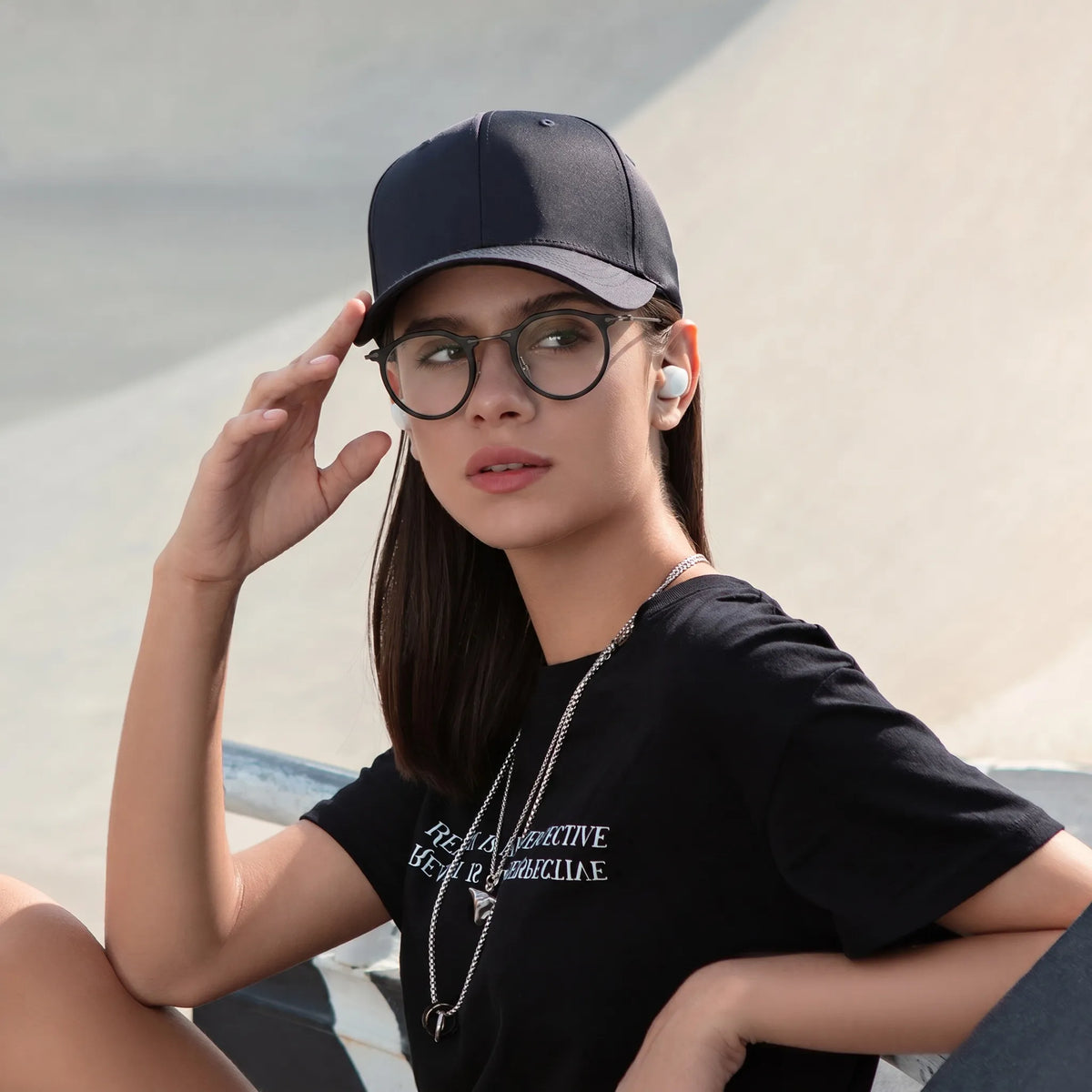 Model wearing Barledear Matte Noir eyeglasses in a lifestyle portrait showing the retro oval acetate metal frame
