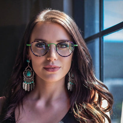 Model wearing Barledear Meadow Violet eyeglasses in a lifestyle portrait with playful geometric frame styling
