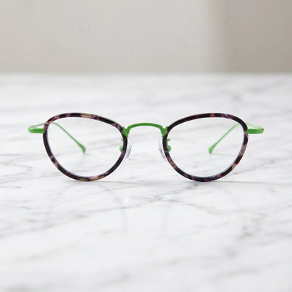Barledear Meadow Violet eyeglasses shown in a clean lifestyle front view with violet patterned acetate and green titanium details