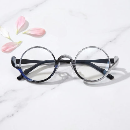 arledear Midnight Graphite eyeglasses folded display showing the round frame shape, slim temples, and artistic color-spliced pure titanium construction