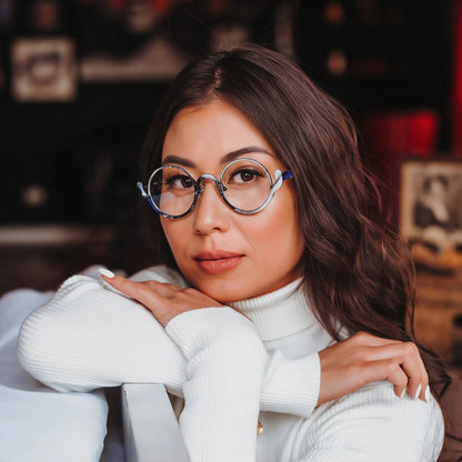Model wearing Barledear Midnight Graphite eyeglasses in a lifestyle portrait showing the artistic round pure titanium frame on the face