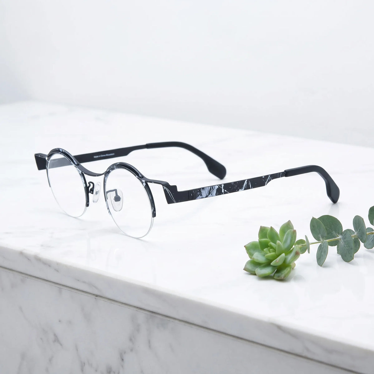 Barledear Midnight Marble eyeglasses angled side view showing black white marble frame details and semi-rimless round structure