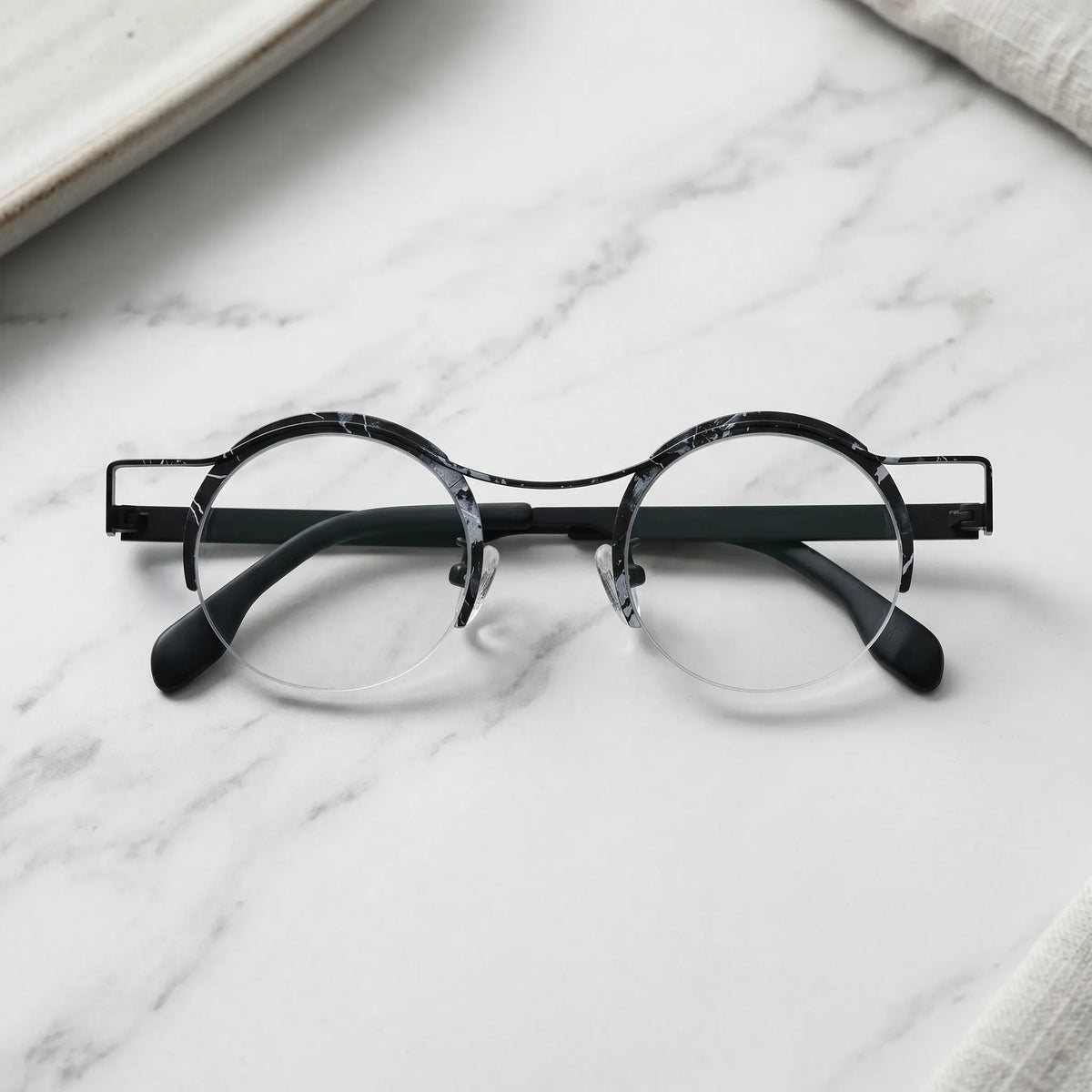 Barledear Midnight Marble eyeglasses folded display showing slim black titanium temples and marble color-spliced finish